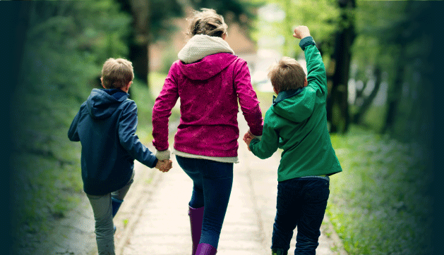 A Family Walking Through the Woods