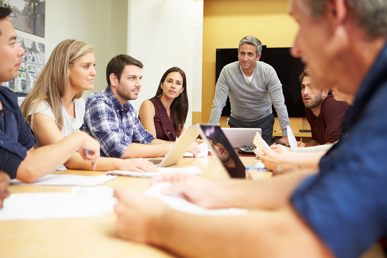 A team of professionals sitting around a table in discussion.