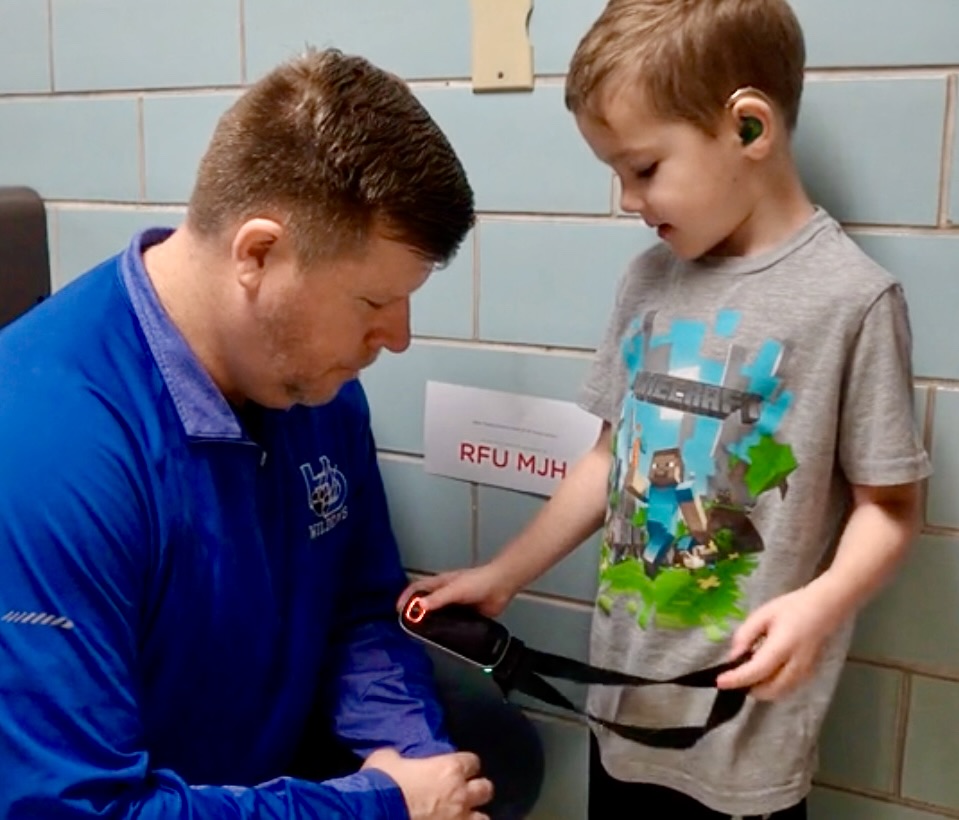 Young child explaining DM device