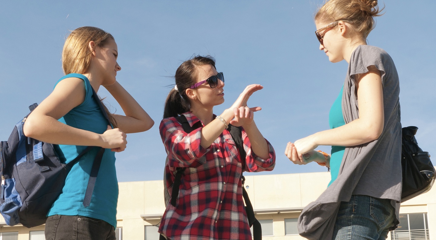 college-age-students-talking-and-signing.jpg